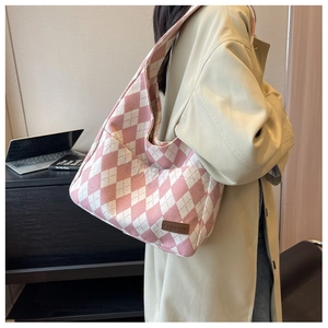 Pink and white rhombic canvas tote bag with fashion label shown in a lifestyle setting