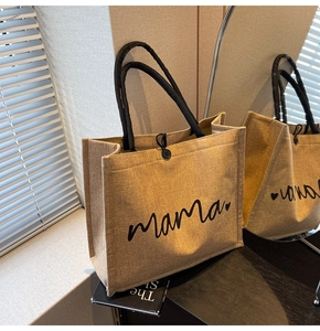 Close-up of natural jute tote bag with black mama script text and button closure detail