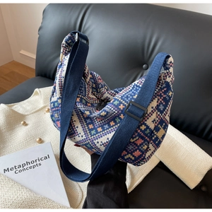 Detail of jacquard ethnic dumpling bag with wide canvas strap and geometric patterns