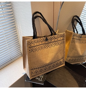 Close-up of geometric pattern on linen tote bag with woven handle and button closure