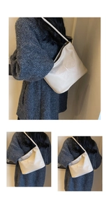Detail view of cream shoulder bag featuring elegant butterfly embroidery and pebble leather