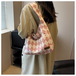 Detail of pink and white argyle canvas shoulder bag with fashion leather patch
