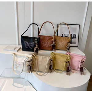 Detailed butterfly embroidery on retro faux leather tote bags with rabbit charms