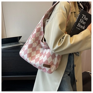 Detailed view of pink and white diamond lattice canvas tote bag worn with stylish outfit