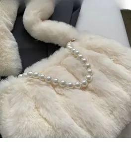 Close-up of soft cream white faux fur texture and elegant large pearl handle detail