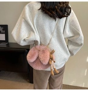 Pink plush bunny crossbody bag with gold chain strap and cute rabbit pendant detail