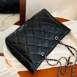 Classic black quilted large tote bag with silver chain strap and polished faux leather finish