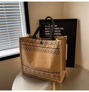 Detail of jute tote bag with black geometric tribal print and thick woven handles