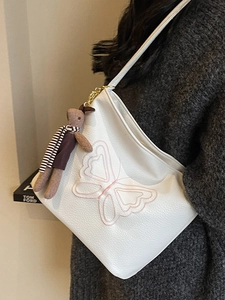 White vintage tote bag with pink butterfly embroidery and a cute rabbit charm