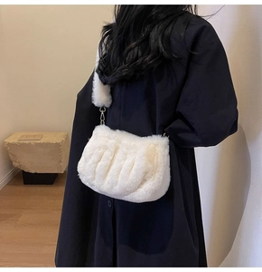 Detailed texture of white faux fur crossbody cloud bag with soft wavy pleated design