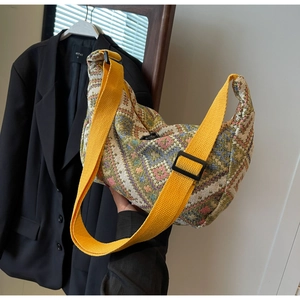 Detail showing woven geometric pattern and yellow adjustable strap of large capacity bag