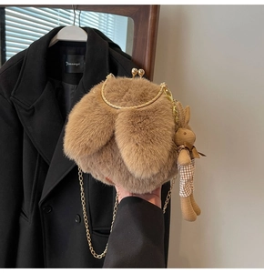 Detail of brown plush bunny ear bag with gold chain strap and rabbit pendant charm