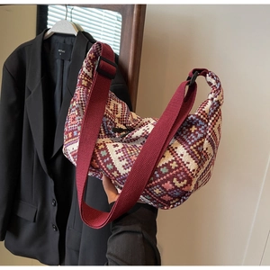 Detailed close-up of bohemian geometric woven texture on large crossbody dumpling bag