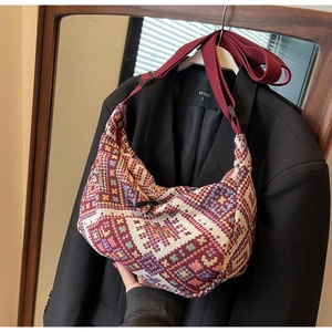 Close-up of ethnic jacquard woven shoulder bag with colorful geometric patterns
