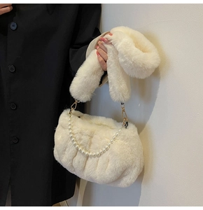 Detail of plush faux fur shoulder bag with pearl chain and thick fuzzy strap