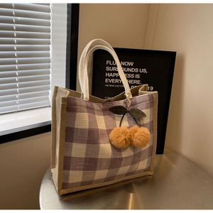 Detail of purple plaid linen tote bag with cotton rope handles and cherry pendant