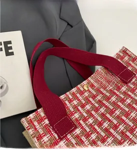 Detail of red and white tweed tote bag with canvas handle and gold snap closure