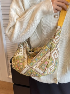 Ethnic style crossbody dumpling bag with colorful geometric woven patterns and yellow strap