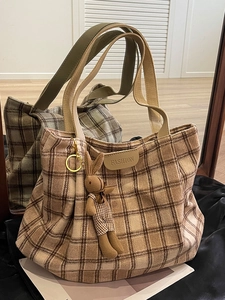 Brown plaid wool tote bag with fashion label and bunny charm shown in mirror reflection