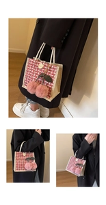 Detail view of red checkered woven handbag with decorative pink cherry plush charms and rope handle