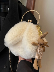 Plush white rabbit crossbody bag with gold handle and cute woven bunny charm