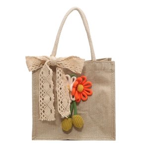 Linen bento tote bag with lace bow and floral embroidery decoration in a minimal style