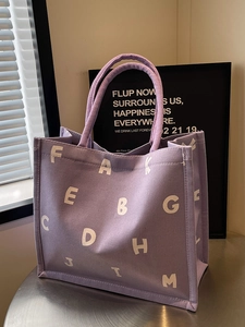 Chic purple canvas tote bag with bold white lettering for stylish commuting and daily use