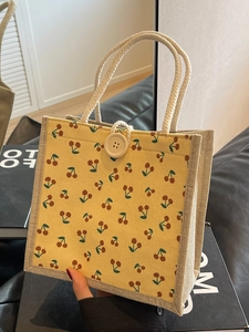 Corduroy handbag with cherry prints and jute trim featuring a decorative button