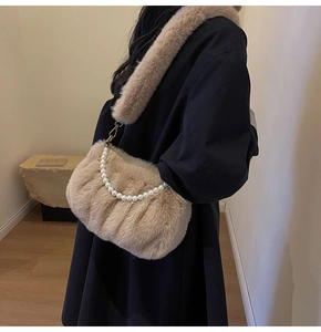 Detail of plush crossbody cloud bag in apricot faux fur with elegant pearl chain handle