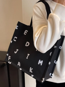Large capacity black canvas tote bag with white letter print for women's stylish daily use