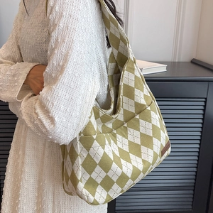Chic green and white diamond pattern canvas tote bag shown with fashion model