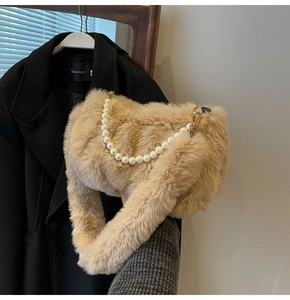 Detail of camel plush shoulder bag featuring soft faux fur and large pearl chain strap