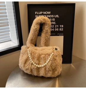 Detail of plush faux fur handbag featuring elegant large white pearl decorative chain