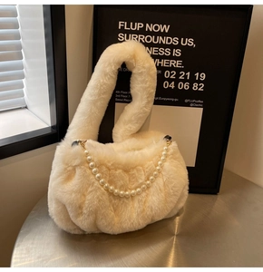 Detailed view of plush cream white cloud bag featuring soft faux fur and pearl chain decor