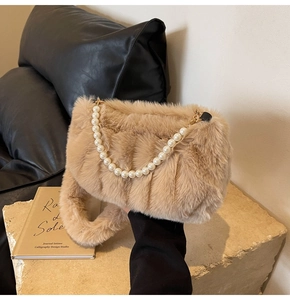 Detailed view of plush khaki cloud bag with decorative large pearl handle and soft strap