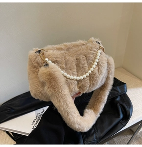 Detail of plush faux fur texture with elegant pearl chain and soft khaki shoulder strap