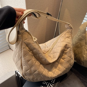 Quilted crossbody moon bag with diamond stitching and adjustable shoulder strap in beige