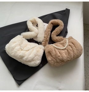 Detailed shot of plush faux fur cloud bags in cream and khaki with pearl chains