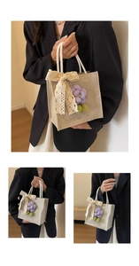 Detail of jute tote bag featuring white cotton rope handles and floral lace bow decorations