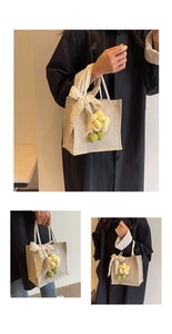 Detail of linen tote bag with lace bow decoration and 3D floral pendant accessory
