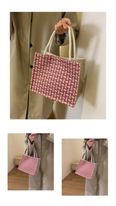 Close-up of red and white checkered woven tote bag with white rope handles and metal clasp