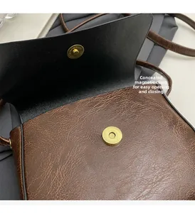 Detail of invisible magnetic closure and vintage cracked leather texture on crossbody bag