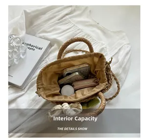 Detailed interior of woven straw tote bag showing spacious lining with gadgets