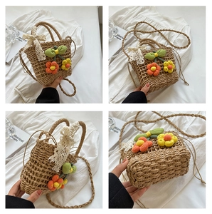 Detail views of handmade straw bag with knit flower decor, lace bow, and long strap