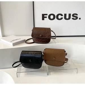 Three vintage crossbody bags in dark brown, black and tan with wax leather textures