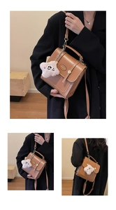 Detail of vintage brown leather backpack with star charm and NANXIAOJIE nameplate