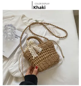 Detail of khaki handmade straw woven mini bag with delicate white lace bow and strap