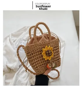 Detail of sunflower khaki hand-woven beach bag featuring floral decor and drawstring liner