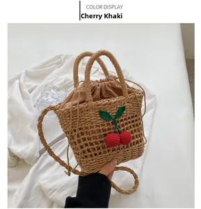 Detail of hand-woven straw crossbody bag in cherry khaki with drawstring lining