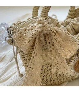 Detail of straw woven tote with lace bow and flower decoration on soft white background
